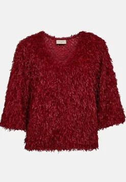 Festtop med fjerlignende materiale